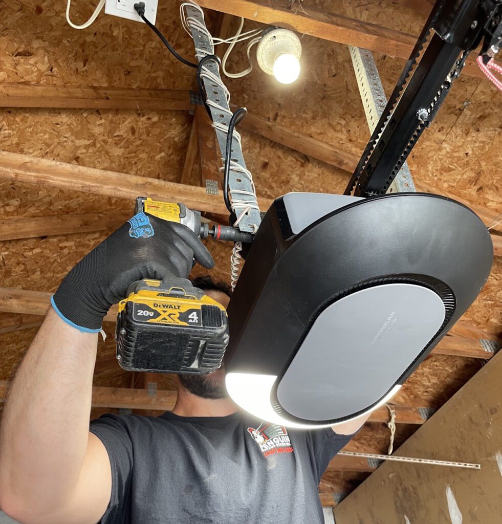 Penguin Garage Doors technician repairing a garage door opener in Richmond Hill.