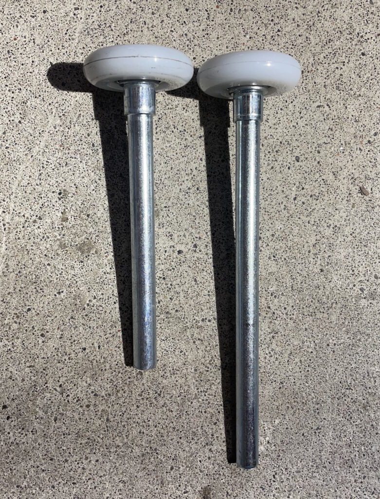 Photo displaying long and short garage door rollers, as part of garage door roller repair and replacement services by Penguin Garage Doors in Thornhill.