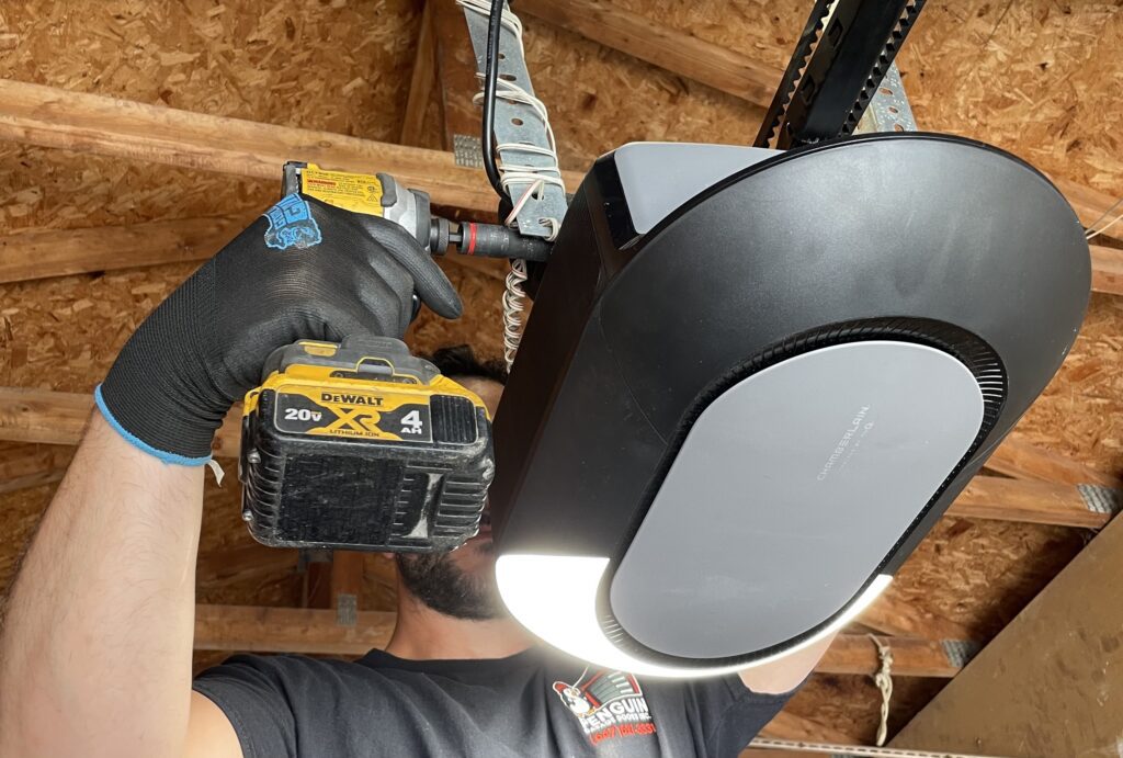Penguin Garage Doors technician installing a new belt drive garage door opener in North York as part of professional garage door opener services.