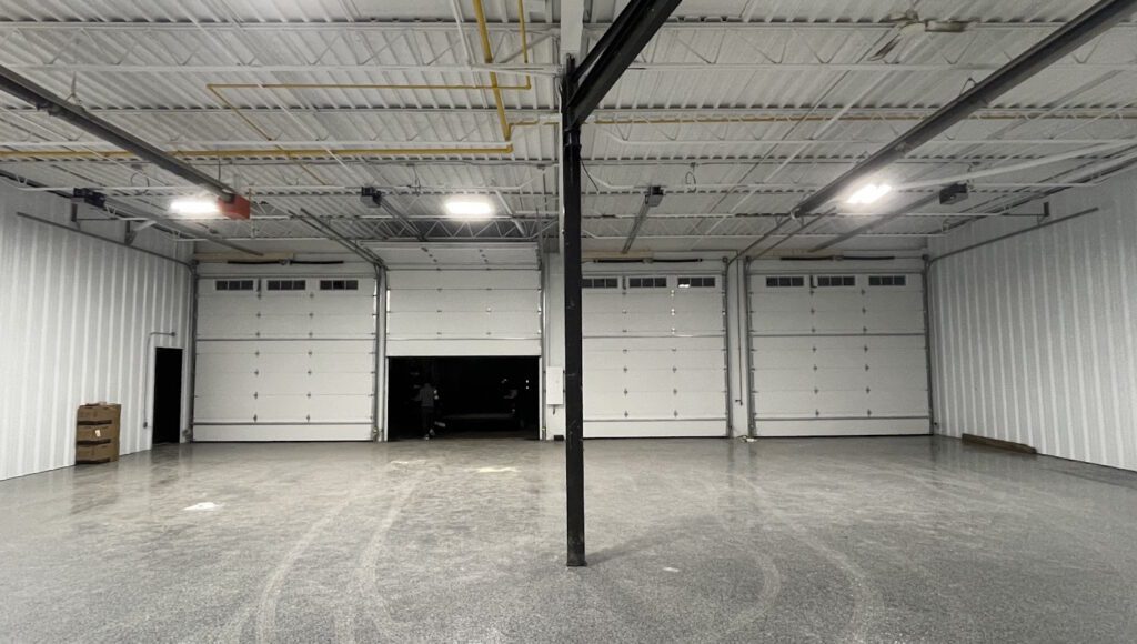 Four new commercial garage doors professionally installed by Penguin Garage Doors, providing durable and reliable solutions for businesses.