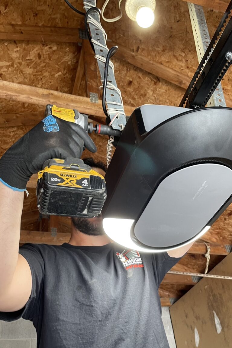 Penguin Garage Doors technician installing a garage door opener for reliable and secure operation.
